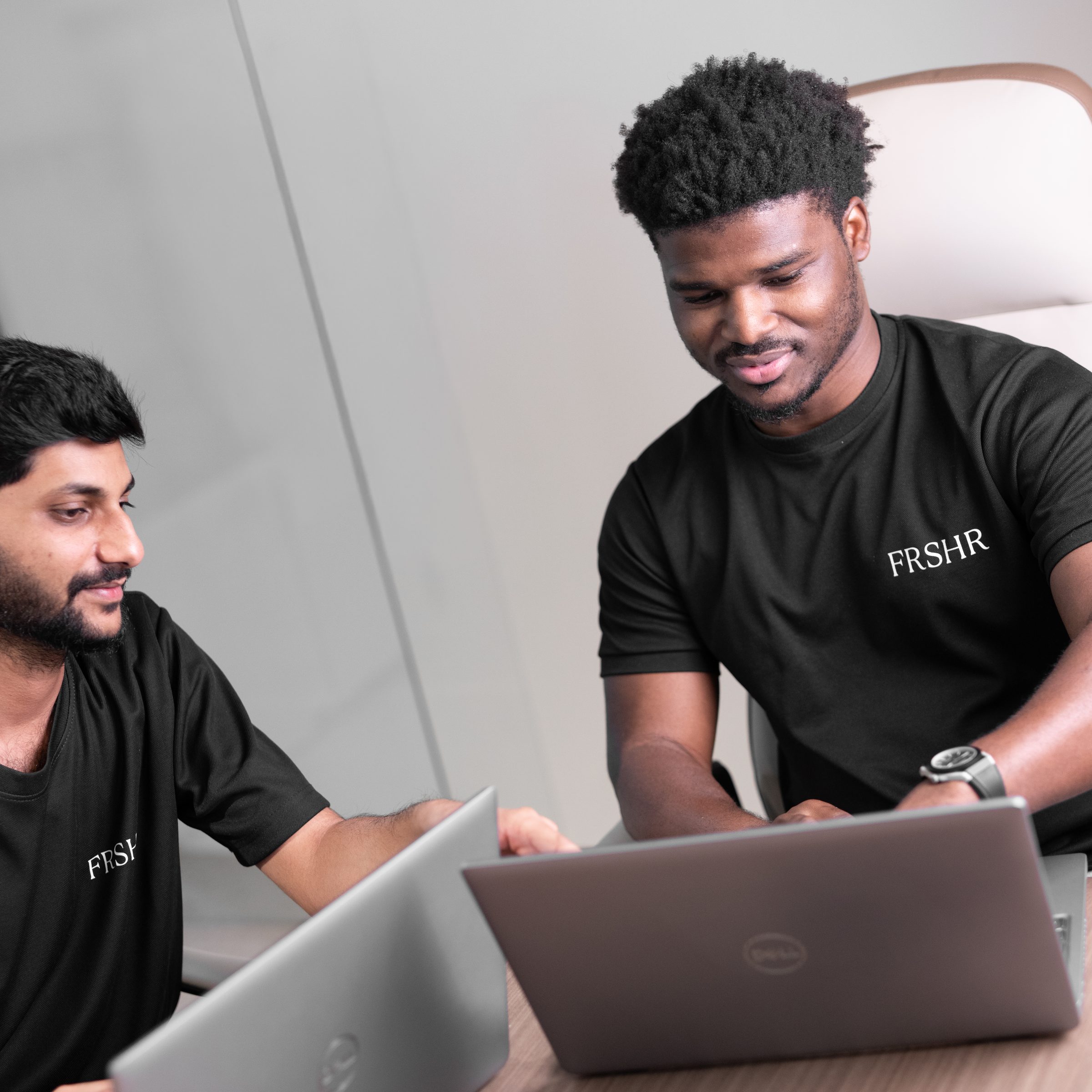 Two FRSHR client advisors working together at their laptops