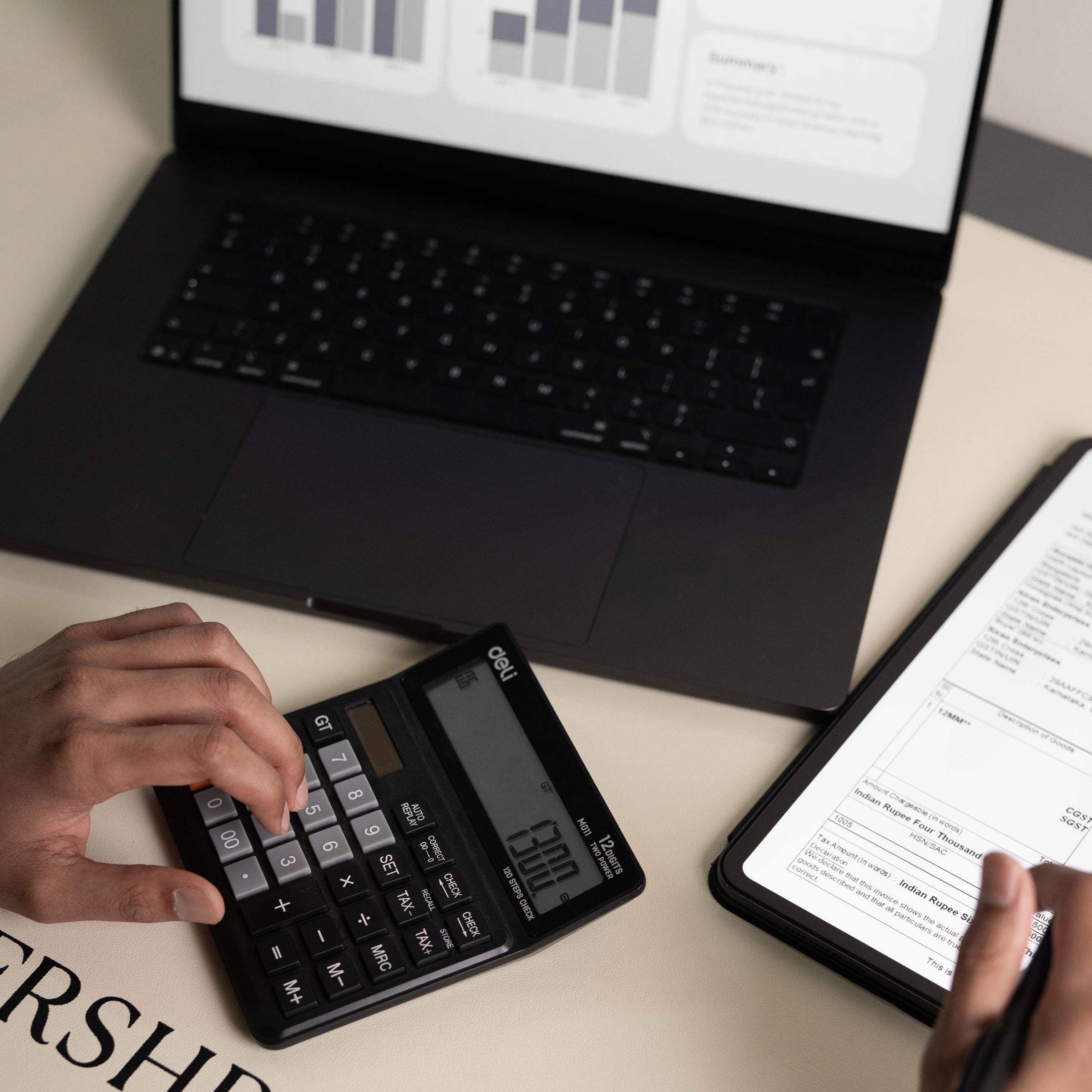 A FRSHR desk with a laptop, calculator and tablet